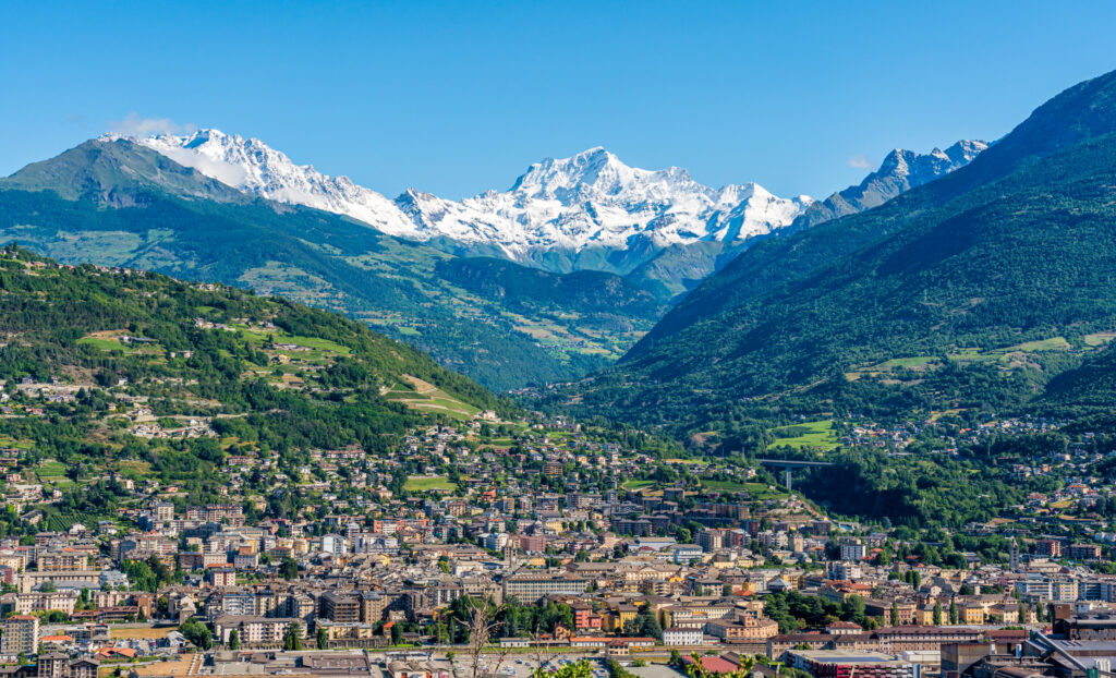 Panoramic view of Aosta with the big Combin mountain in the background. Aosta Valley Northern Italy.