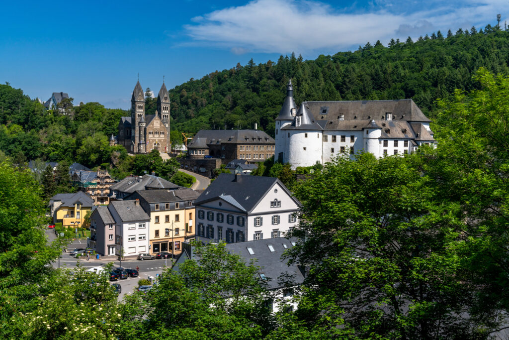 View of the picturesque and historic city center of Clervaux with castle and church in northern Luxembourg