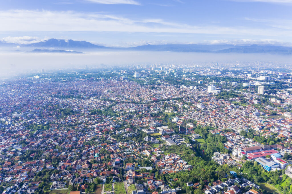 Beautiful aerial view of Bandung cityscape on misty morning, West Java, Indonesia