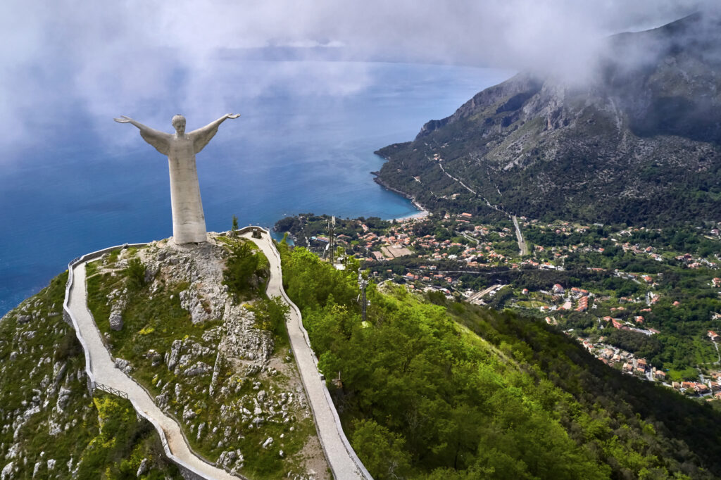 View at green hill with statue in Maratea town in Italy